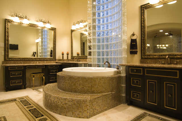 Photo of an expansive traditional master bathroom in Houston with an undermount sink, flat-panel cabinets, dark wood cabinets, granite benchtops, a drop-in tub, a shower/bathtub combo, a two-piece toilet, beige tile, porcelain tile, beige walls and ceramic floors.