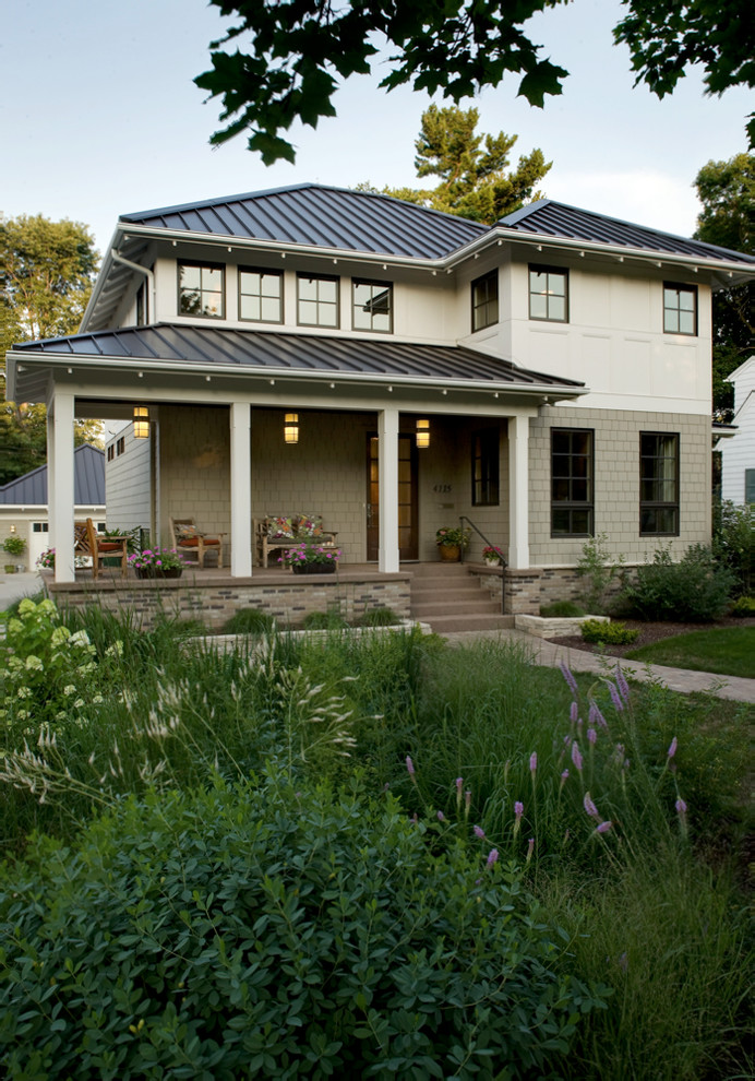 Design ideas for a transitional two-storey white exterior in Minneapolis with a metal roof.