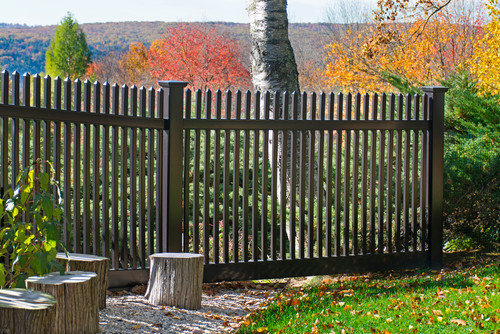 A simple vinyl fence designed to resemble a wrought iron fence. The fence can be seen through, which keeps the beautiful view of the valley below visible.