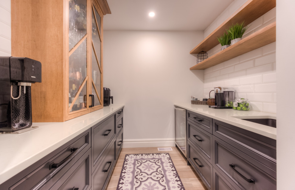 Kitchen - transitional galley kitchen idea in Toronto with shaker cabinets, white backsplash and white countertops