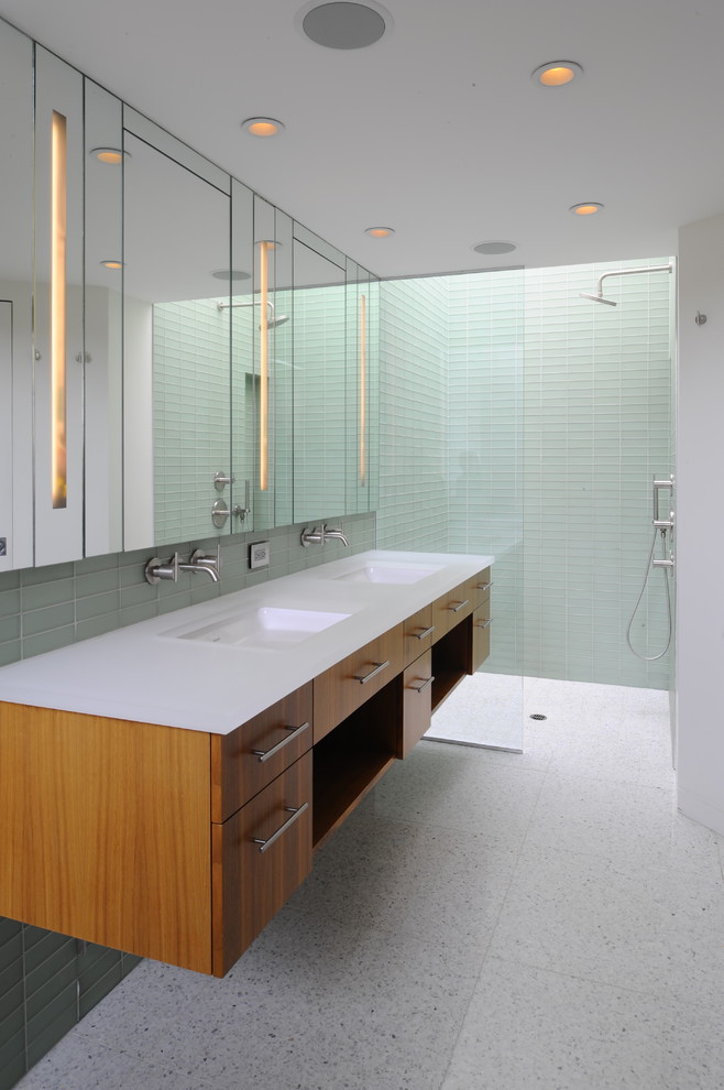 Inspiration for a mid-sized contemporary master bathroom in San Francisco with an integrated sink, flat-panel cabinets, medium wood cabinets, a curbless shower, a one-piece toilet, green tile, glass tile, green walls, porcelain floors and an alcove tub.
