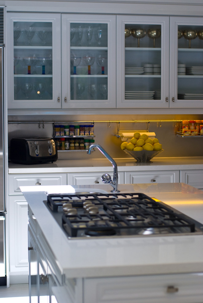 Large transitional u-shaped marble floor eat-in kitchen photo in Toronto with a single-bowl sink, raised-panel cabinets, white cabinets, solid surface countertops, stainless steel appliances and a peninsula
