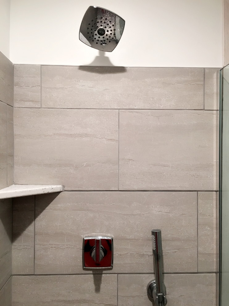 This is an example of a mid-sized transitional bathroom in Detroit with an alcove shower, a two-piece toilet, beige tile, brown tile, porcelain tile, beige walls, porcelain floors, beige floor and an open shower.