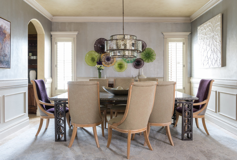 Photo of a mid-sized transitional separate dining room in Other with grey walls, carpet and grey floor.