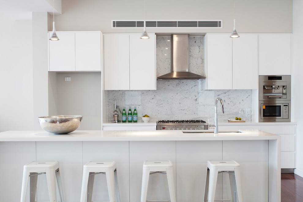 Design ideas for a contemporary kitchen in Sydney with white splashback, stone slab splashback and with island.