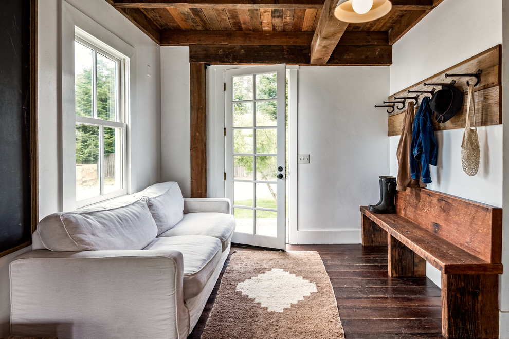 Design ideas for a country mudroom in San Francisco with white walls, dark hardwood floors, a single front door, a glass front door and brown floor.
