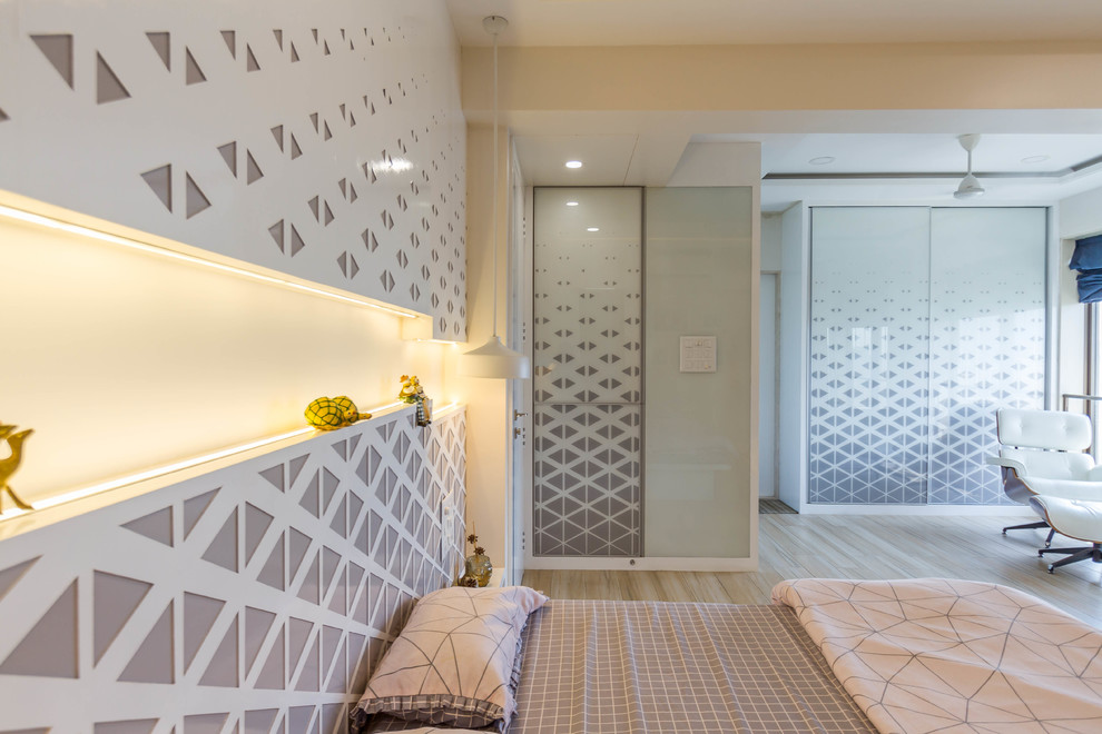 Photo of a contemporary Gender-neutral kid's room in Mumbai With White Walls and Light Hardwood Floors.