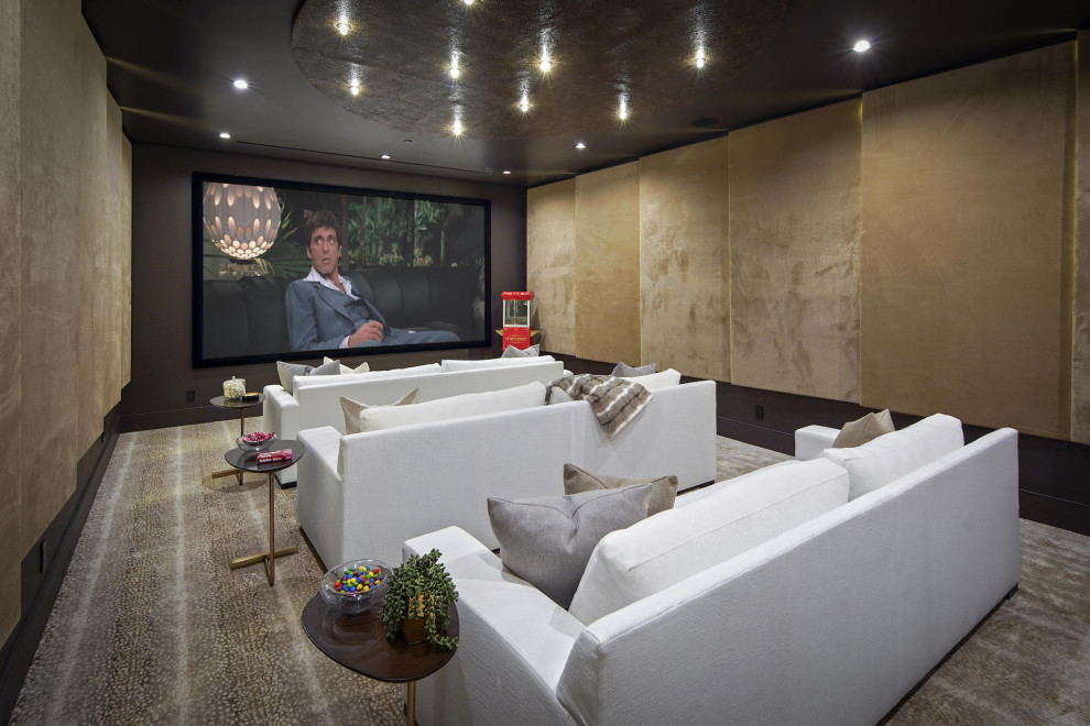 Photo of a large contemporary enclosed home cinema in San Francisco with beige walls, carpet, a projector screen and brown floors.