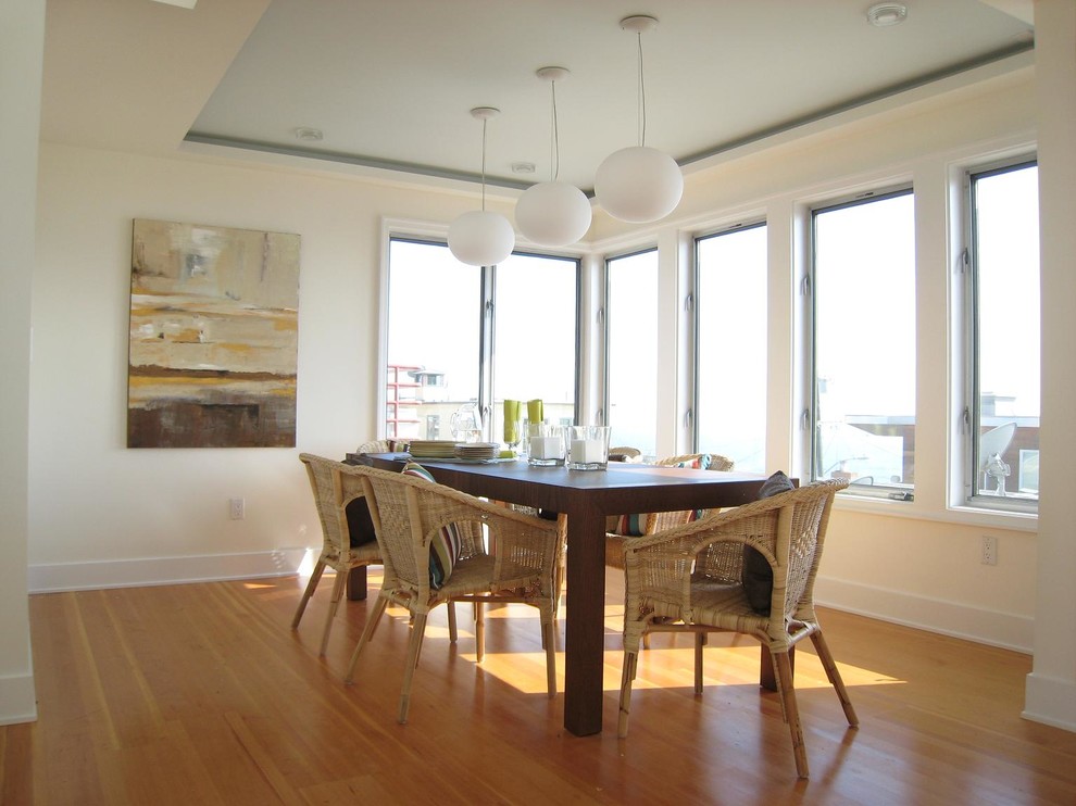 Contemporary dining room in Los Angeles with beige walls and medium hardwood floors.