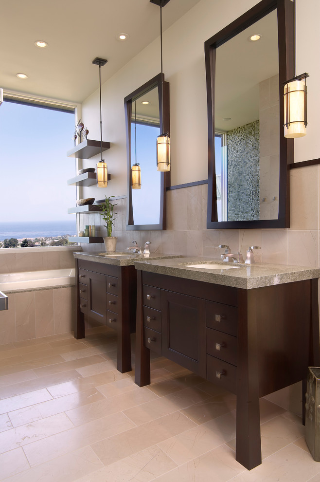 Design ideas for a mid-sized beach style master bathroom in San Diego with dark wood cabinets, a drop-in tub, blue tile, green tile, mosaic tile, beige walls, porcelain floors, an undermount sink, granite benchtops, beige floor and recessed-panel cabinets.