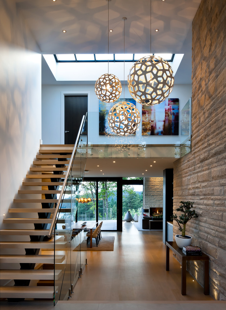 Inspiration for a contemporary foyer in Vancouver with white walls and light hardwood floors.