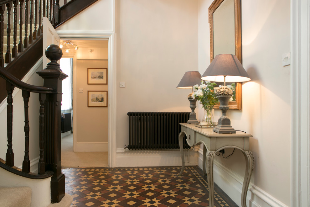 Large traditional hallway in Dorset with beige walls and ceramic floors.