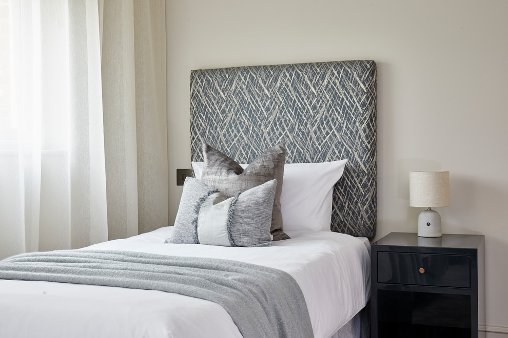 Inspiration for a transitional guest bedroom in London with grey walls and no fireplace.