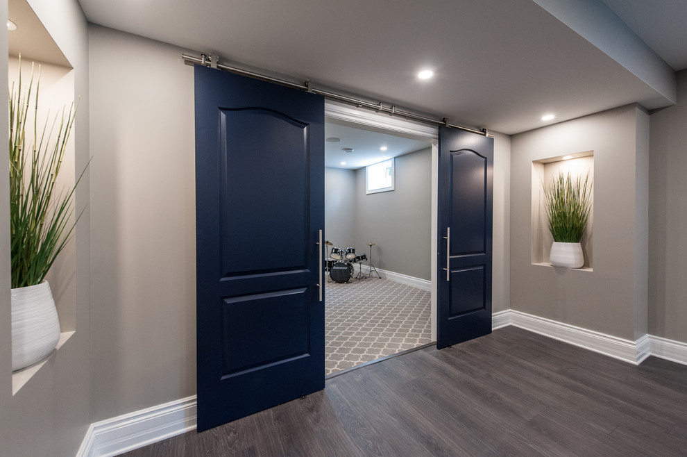 A basement with a hue of blue and sparkle Transitional Basement
