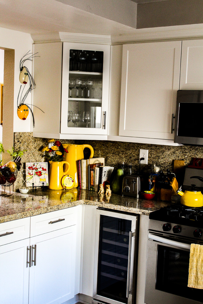 Mid-sized transitional u-shaped porcelain tile and beige floor enclosed kitchen photo with an undermount sink, shaker cabinets, white cabinets, granite countertops, brown backsplash, stone slab backsplash, stainless steel appliances, no island and brown countertops