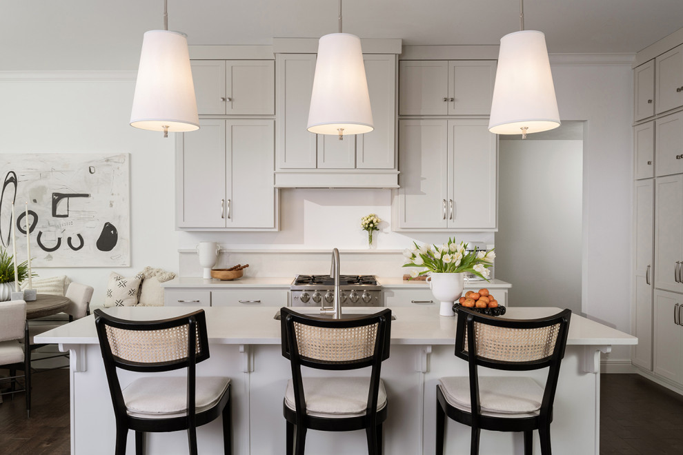 Example of a mid-sized u-shaped open concept kitchen design with gray cabinets and an island