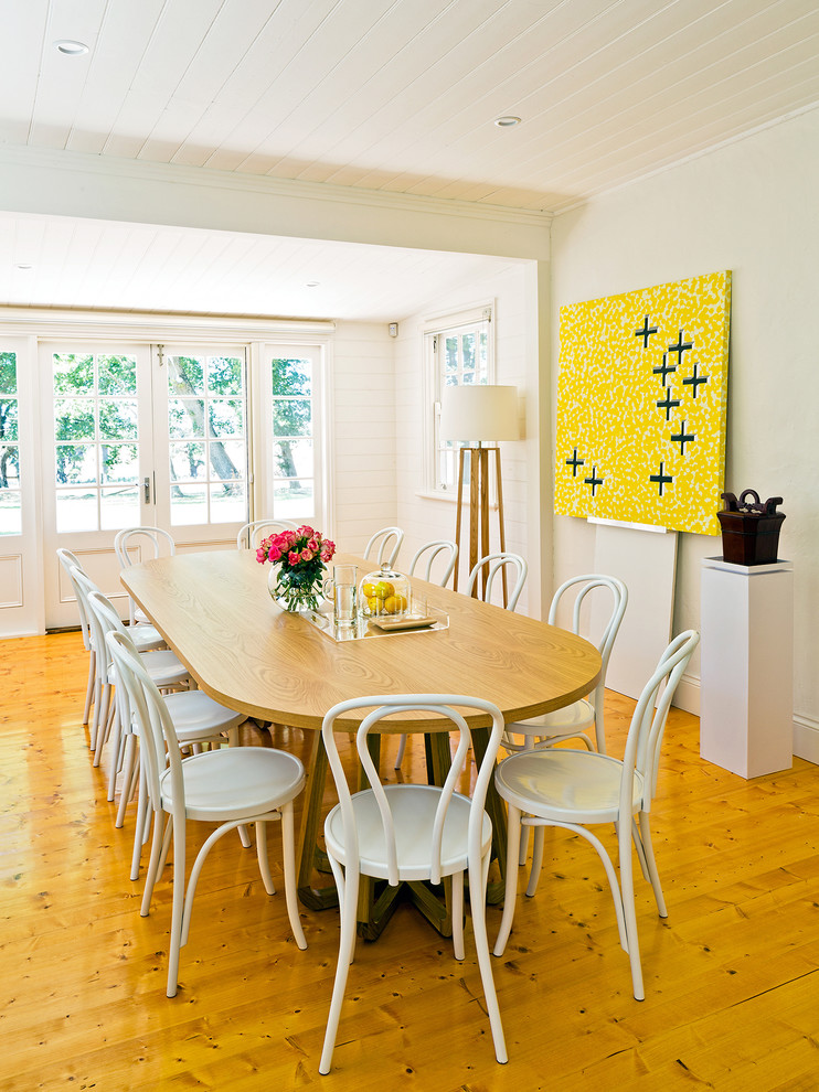 Photo of a mid-sized country dining room in Melbourne with medium hardwood floors and grey walls.