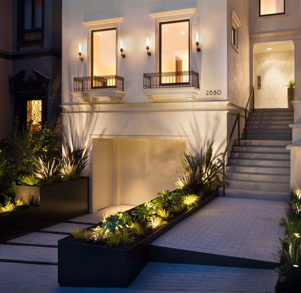 This is an example of a transitional front yard partial sun garden in San Francisco with a garden path and brick pavers.