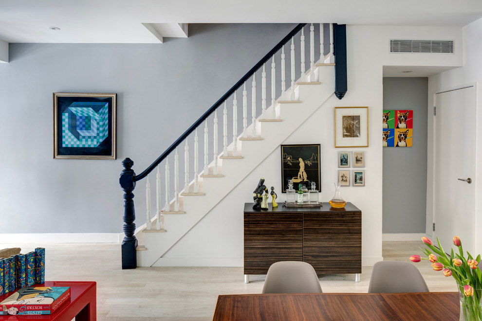 Design ideas for a transitional wood straight staircase in New York with painted wood risers.