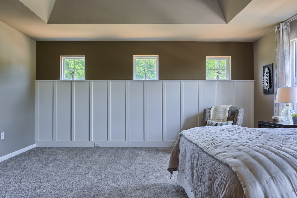 This is an example of an expansive traditional master bedroom in Philadelphia with beige walls and carpet.