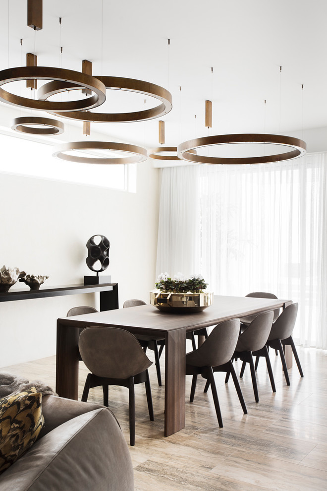 Photo of a contemporary dining room in Melbourne with white walls and beige floor.