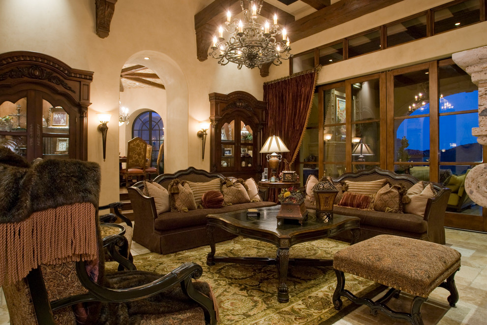Photo of an expansive mediterranean enclosed family room in Phoenix with a library, beige walls, dark hardwood floors, a standard fireplace, a stone fireplace surround, a wall-mounted tv and brown floor.