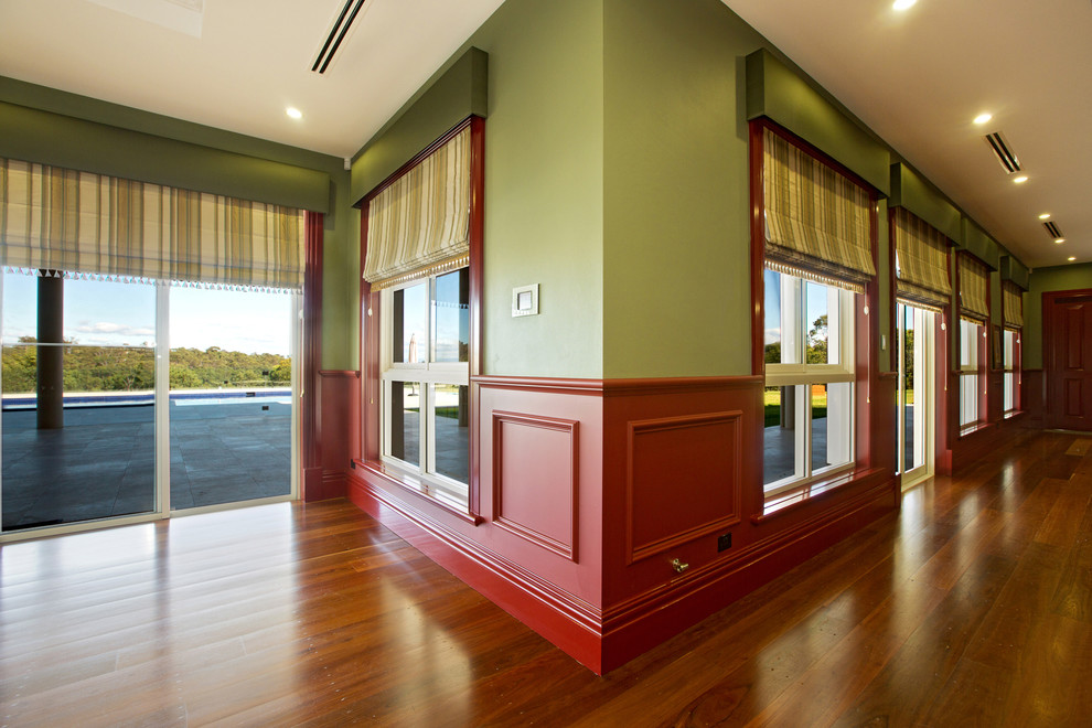 Design ideas for an expansive traditional open concept family room in Sydney with a game room, multi-coloured walls and medium hardwood floors.