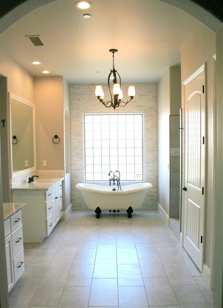 Photo of a large contemporary master bathroom in Other with raised-panel cabinets, white cabinets, a claw-foot tub, an alcove shower, beige walls and an undermount sink.
