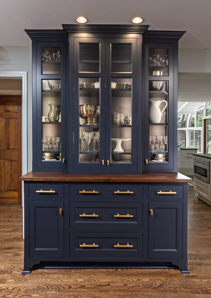 Transitional medium tone wood floor and brown floor eat-in kitchen photo in Milwaukee with beaded inset cabinets, blue cabinets, wood countertops and brown countertops