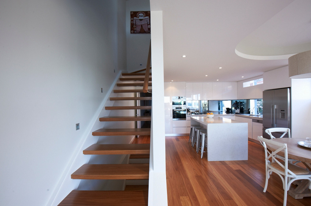 Inspiration for a mid-sized contemporary eat-in kitchen in Sydney with medium hardwood floors.