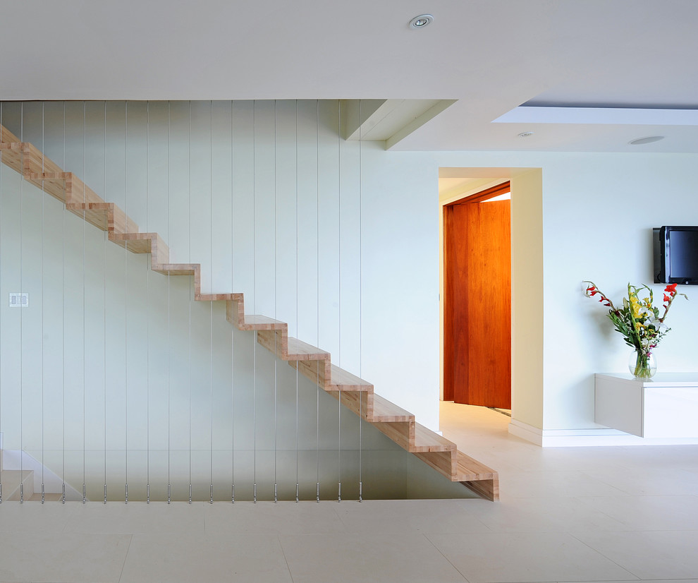This is an example of a contemporary floating staircase in Miami with cable railing.
