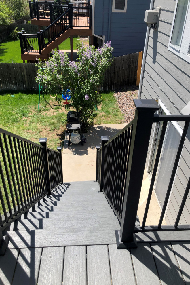 Mid-sized backyard second story metal railing deck photo with no cover
