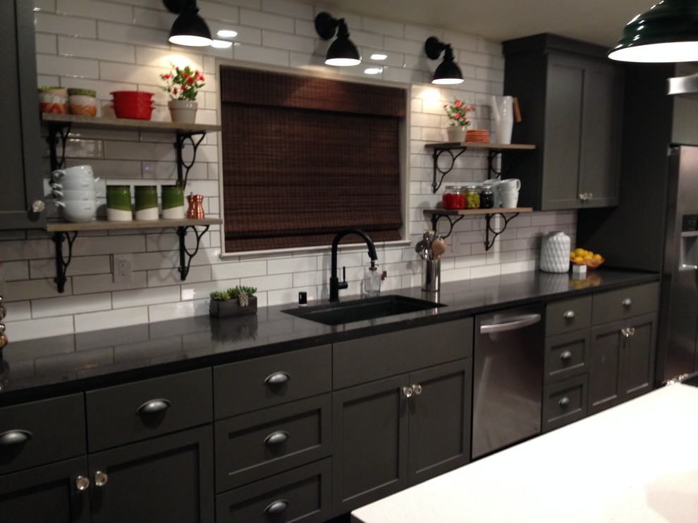 Inspiration for a large country l-shaped kitchen in Sacramento with an undermount sink, shaker cabinets, black cabinets, white splashback, subway tile splashback, stainless steel appliances and with island.