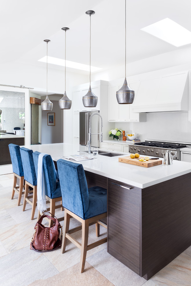 Design ideas for a mid-sized contemporary single-wall eat-in kitchen in Vancouver with a double-bowl sink, shaker cabinets, white cabinets, white splashback, stainless steel appliances, solid surface benchtops, with island, multi-coloured floor and white benchtop.