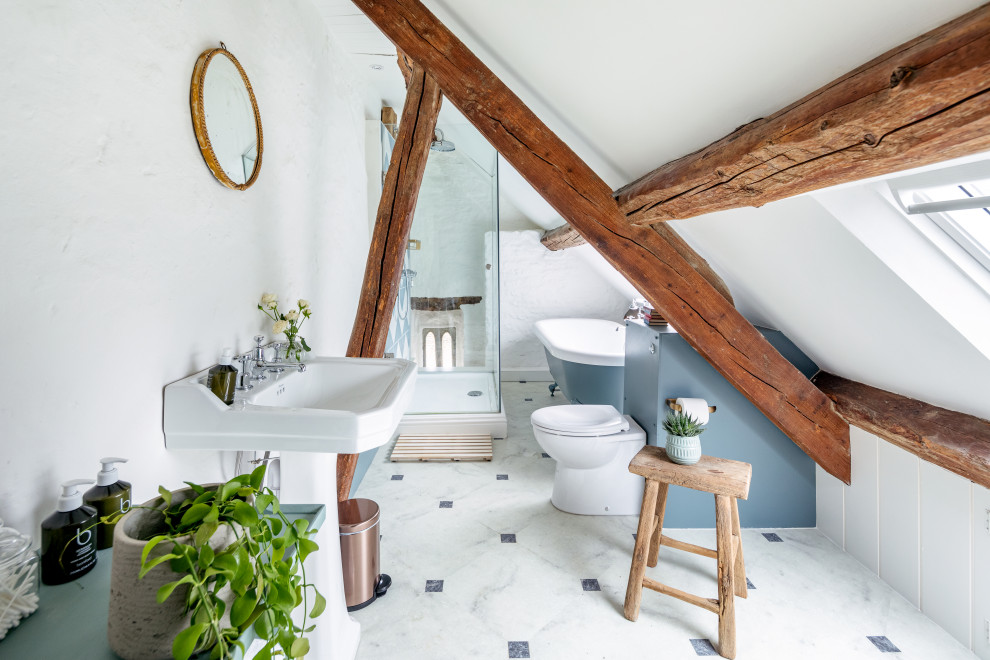 Transitional kids bathroom in London with white cabinets, a one-piece toilet, white walls, a pedestal sink, multi-coloured floor, a hinged shower door, a single vanity, a built-in vanity, exposed beam, vaulted and panelled walls.