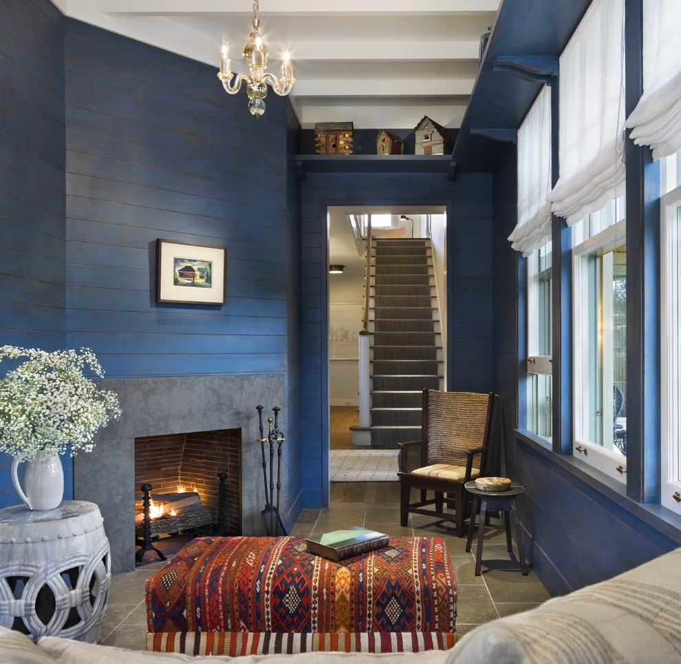 Design ideas for a small beach style enclosed family room in Boston with blue walls, a corner fireplace, porcelain floors, a concrete fireplace surround and grey floor.