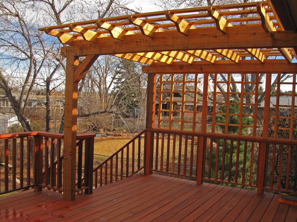 Mid-sized traditional backyard deck in Denver with a pergola.