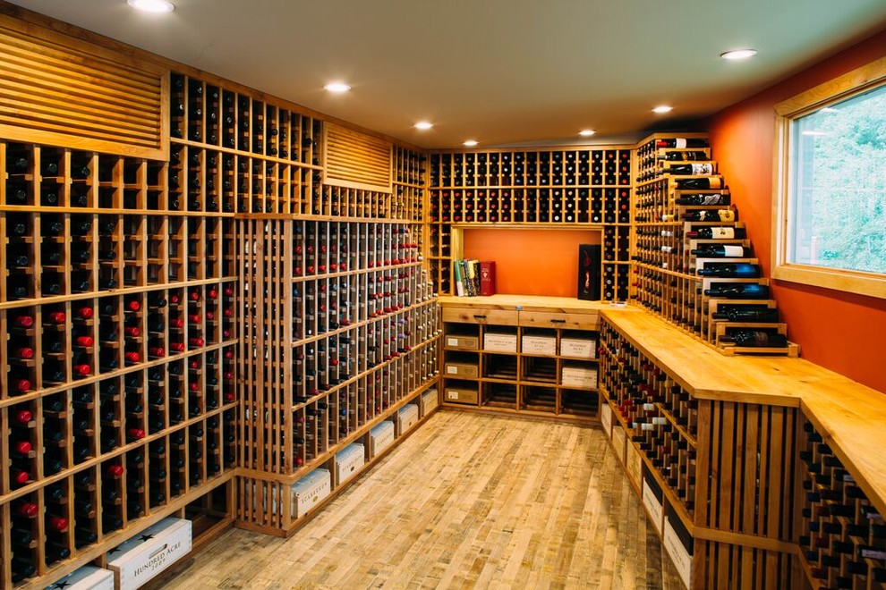 Inspiration for a large traditional wine cellar in Los Angeles with light hardwood floors and storage racks.