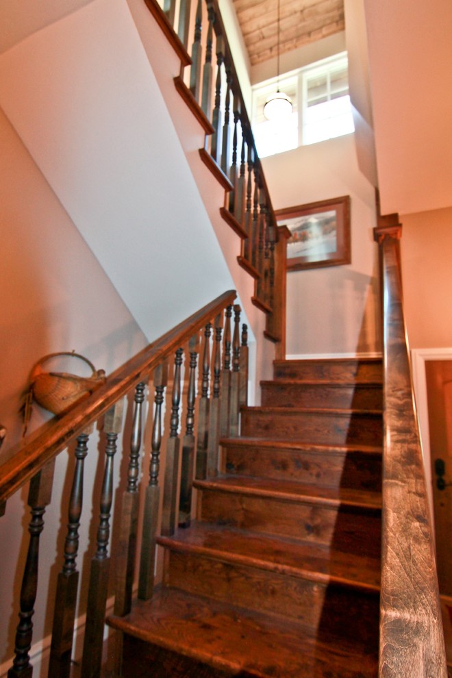 This is an example of a mid-sized country wood straight staircase in Dallas with wood risers.