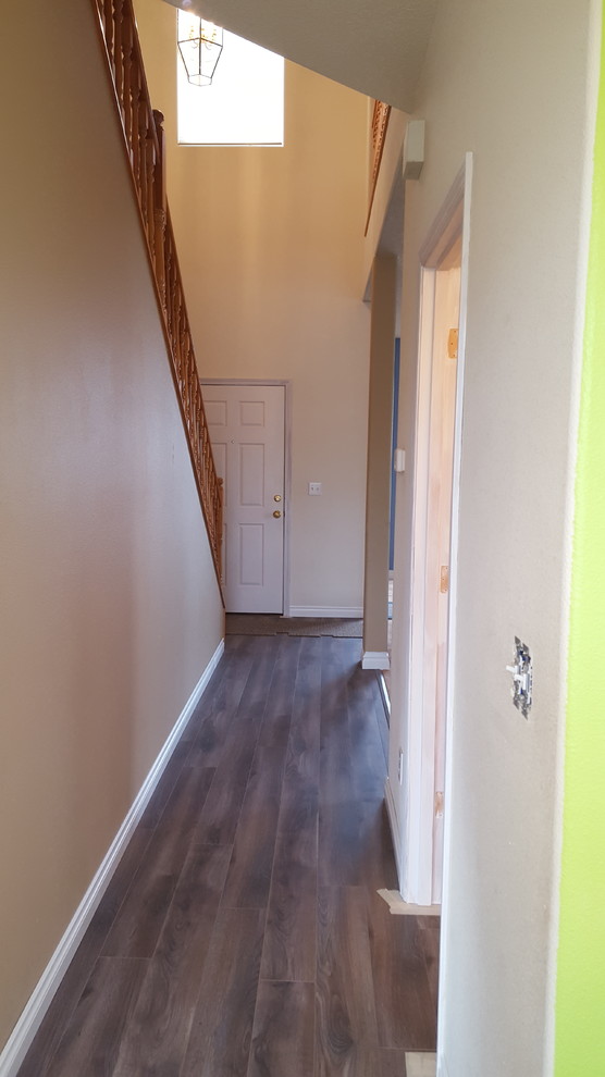 Inspiration for a mid-sized transitional medium tone wood floor hallway remodel with gray walls