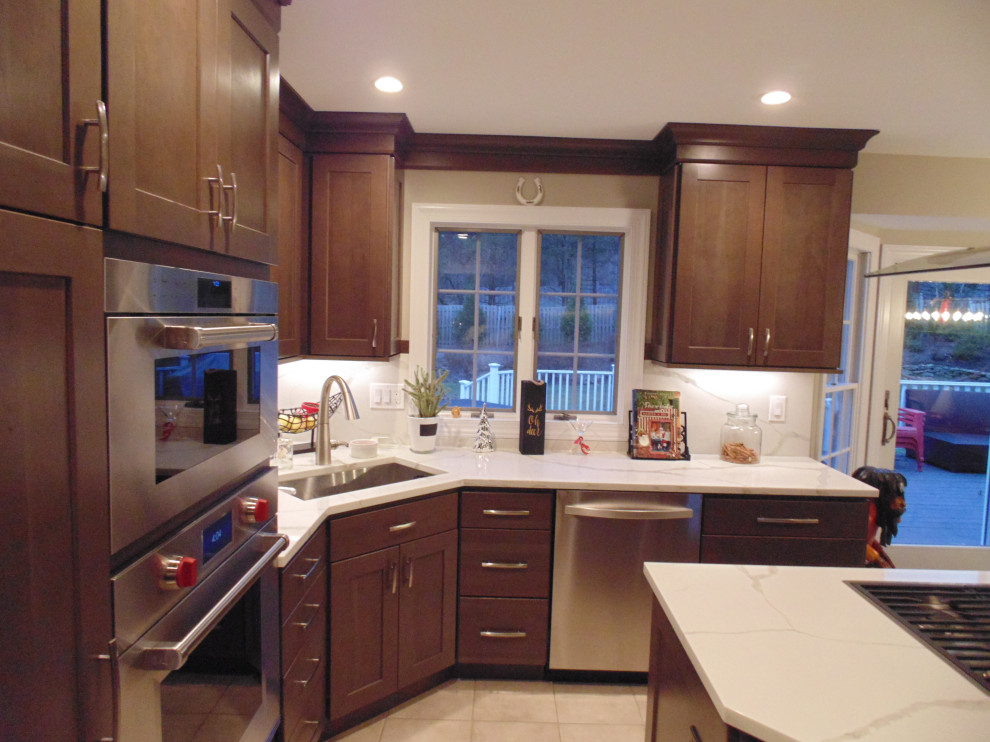 Eat-in kitchen - mid-sized transitional u-shaped ceramic tile and beige floor eat-in kitchen idea with an undermount sink, recessed-panel cabinets, dark wood cabinets, quartz countertops, white backsplash, stone slab backsplash, stainless steel appliances, an island and white countertops