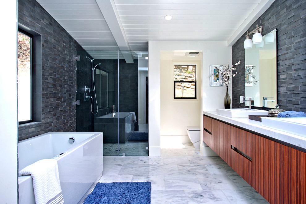 Photo of a midcentury master bathroom in Los Angeles with an alcove shower, gray tile and marble floors.
