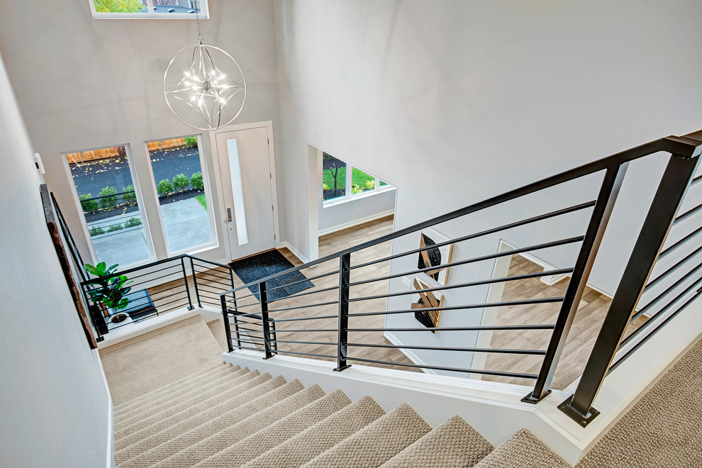 Photo of a mid-sized contemporary foyer in Seattle with white walls, light hardwood floors and a single front door.