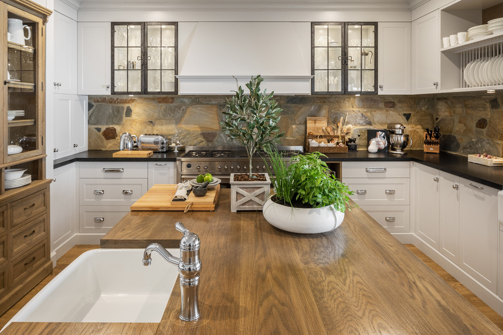 Design ideas for a large country kitchen in Perth with an undermount sink, shaker cabinets, grey cabinets, granite benchtops, brown splashback, stainless steel appliances, medium hardwood floors, with island, slate splashback and black benchtop.