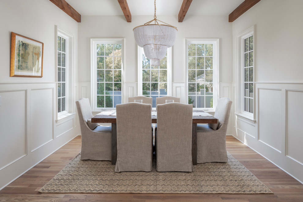 Photo of a large beach style open plan dining in Charlotte with beige walls, medium hardwood floors and brown floor.
