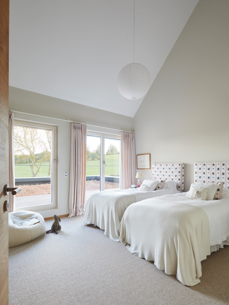 Inspiration for a mid-sized contemporary guest bedroom in Hampshire with carpet and beige floor.