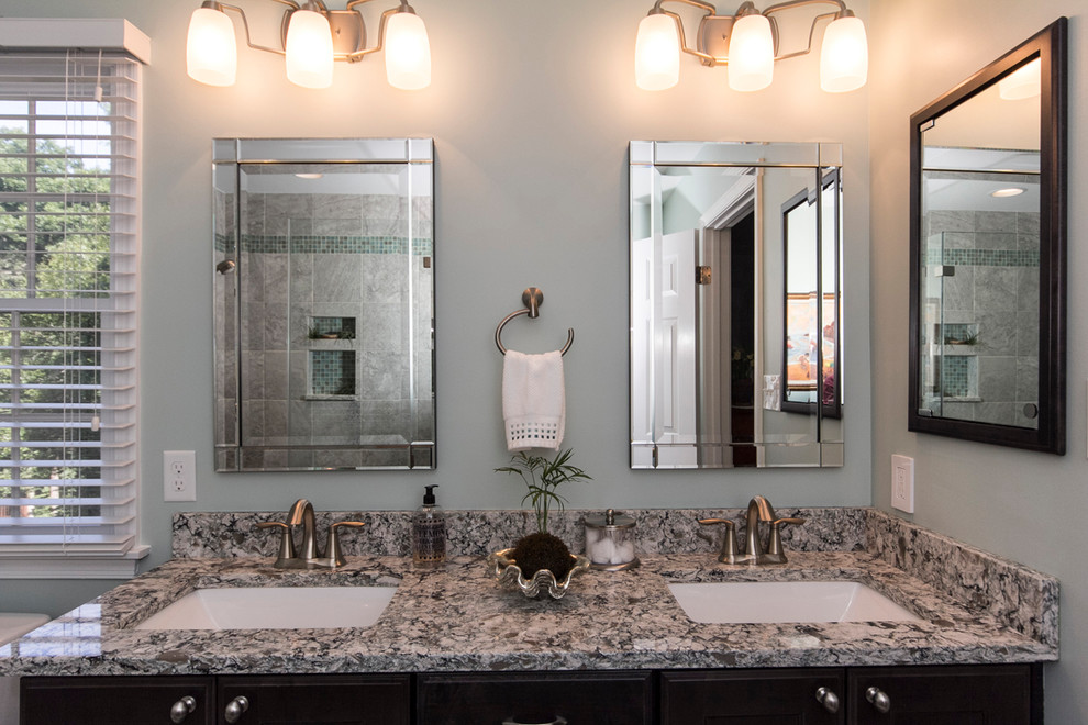 Example of a mid-sized transitional master gray tile and porcelain tile porcelain tile and gray floor alcove shower design in DC Metro with recessed-panel cabinets, dark wood cabinets, a two-piece toilet, blue walls, an undermount sink, quartz countertops and a hinged shower door