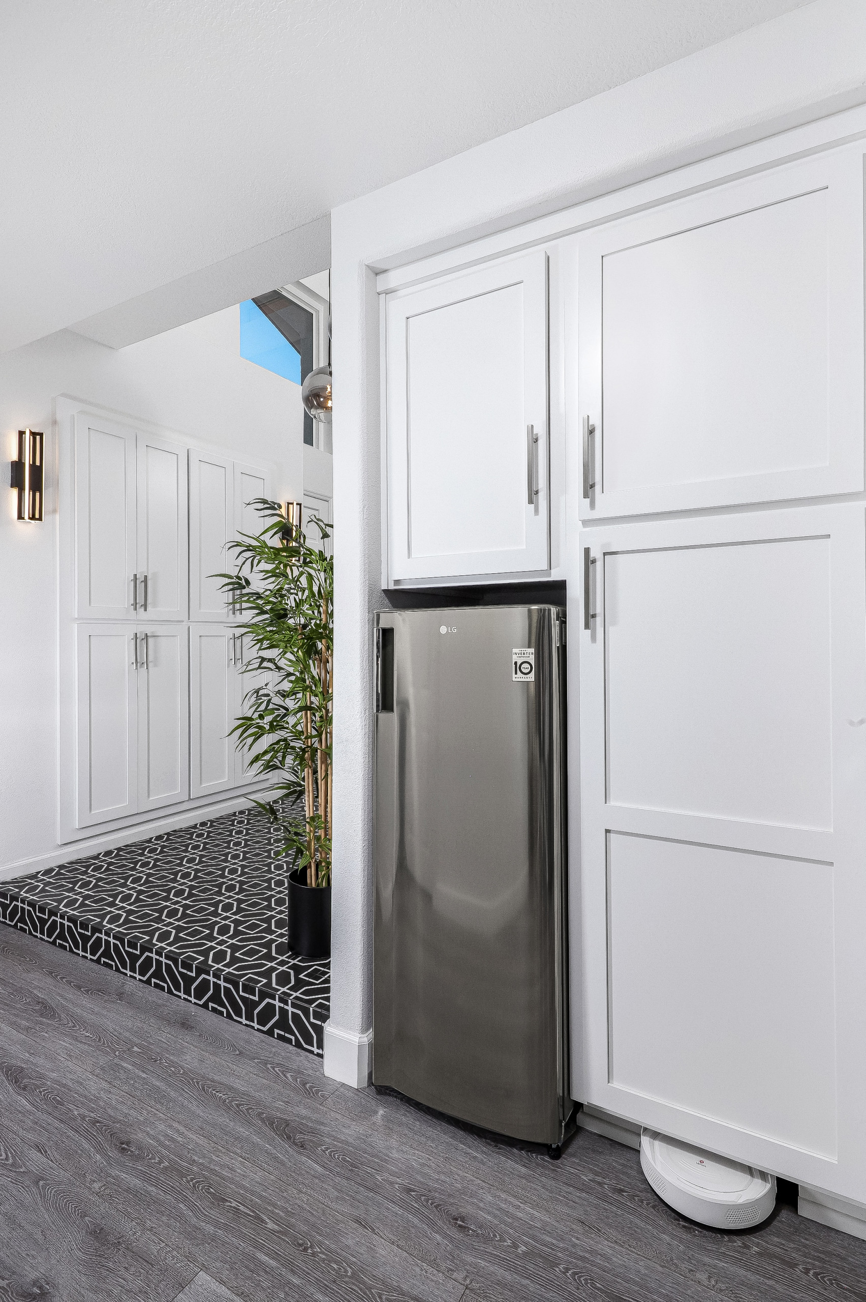 Custom White Shaker Cabinetry Butlers Pantry with Built-in Roomba Storage.