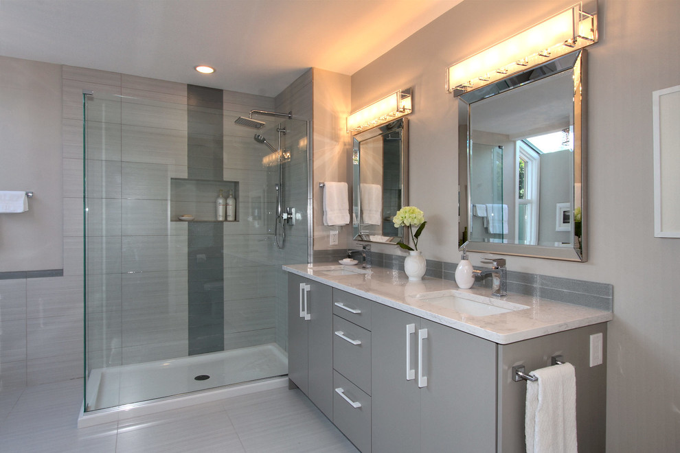Design ideas for a mid-sized contemporary master bathroom in Vancouver with flat-panel cabinets, grey cabinets, a corner shower, grey walls, an undermount sink, marble benchtops, a hinged shower door and a freestanding tub.