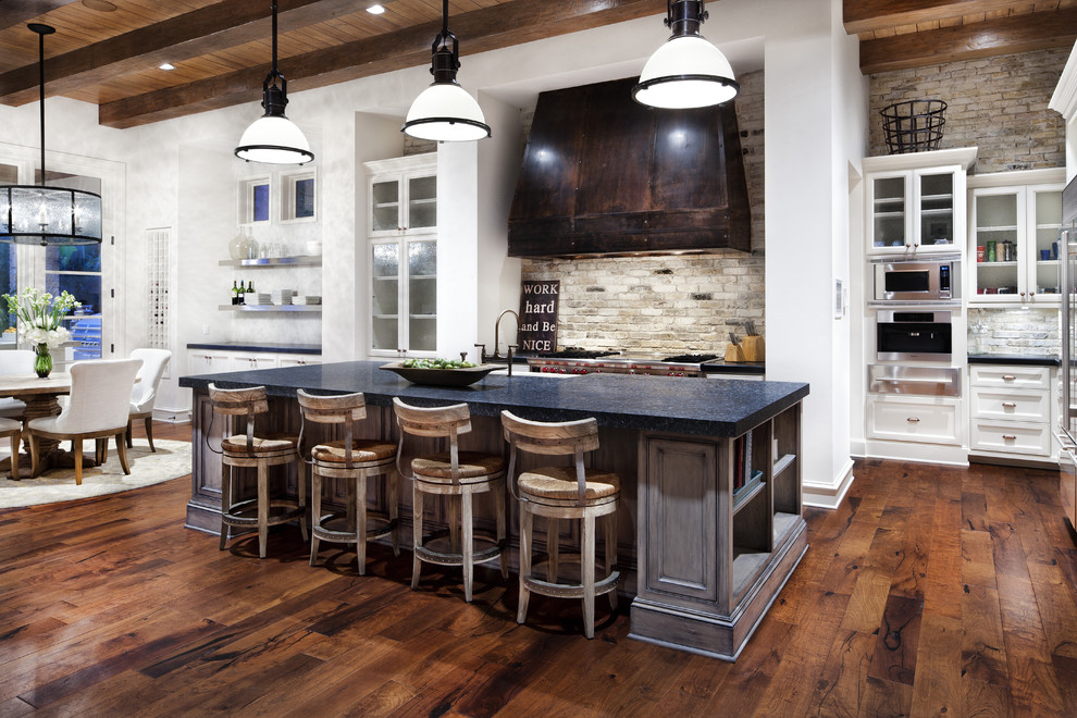 Traditional eat-in kitchen in Austin with white cabinets and stainless steel appliances.